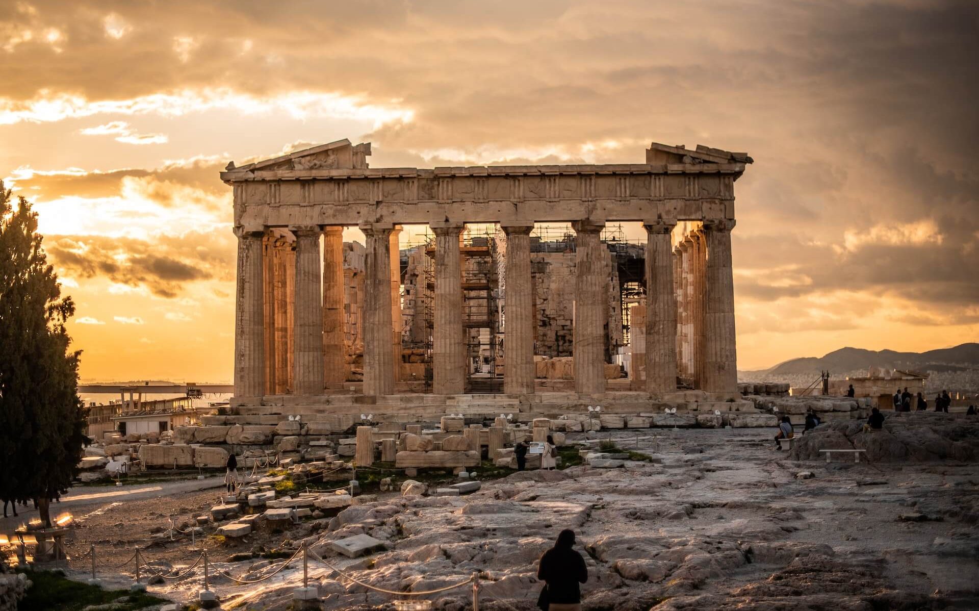 Stunning Greek temple silhouetted against a mesmerizing sunset, creating an awe-inspiring backdrop.