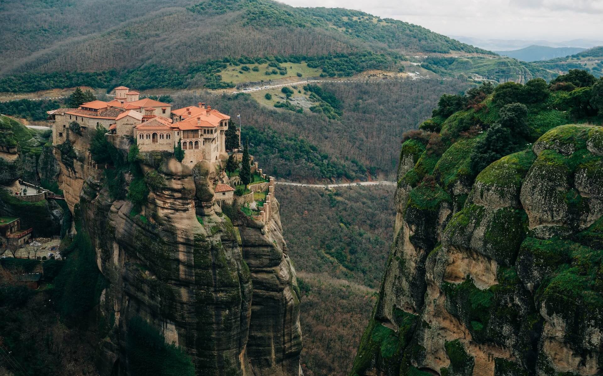 Marveling at the gravity-defying Meteora Monasteries in Greece, perched atop towering rock formations, a testament to human ingenuity and devotion.